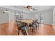 Open-concept dining room with wood floors and modern ceiling fans at 155 Patty Ann Blvd, Palm Harbor, FL 34683