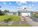 Charming single-story home with a well-manicured lawn and a two-car garage in a quiet residential neighborhood at 155 Patty Ann Blvd, Palm Harbor, FL 34683