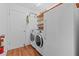 Laundry area with modern washer and dryer, shelving, and additional storage space at 155 Patty Ann Blvd, Palm Harbor, FL 34683