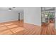 Bright and airy living room featuring wood-look floors and neutral wall paint at 155 Patty Ann Blvd, Palm Harbor, FL 34683