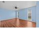 Bright main bedroom with wood floors and two large windows at 155 Patty Ann Blvd, Palm Harbor, FL 34683
