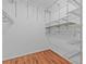 Walk-in closet featuring wire shelving and laminate floors at 155 Patty Ann Blvd, Palm Harbor, FL 34683