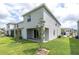 The back of the home features a small covered patio and a small yard at 16177 Glowing Grove Ave, Odessa, FL 33556
