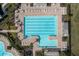 Aerial of the competition-sized swimming pool with lounge chairs and shade structures near the clubhouse at 16177 Glowing Grove Ave, Odessa, FL 33556