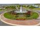 A beautiful fountain surrounded by palm trees and landscaping at the entrance of the community at 16177 Glowing Grove Ave, Odessa, FL 33556