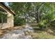 Tranquil backyard with mature trees and a path leading through the lush greenery at 1641 Bayfield Ct, Trinity, FL 34655