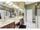 Bright bathroom featuring double sinks, ample counter space, and a separate water closet for privacy at 1641 Bayfield Ct, Trinity, FL 34655