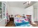 Cozy bedroom with colorful decorations, ceiling fan, and a big window at 1641 Bayfield Ct, Trinity, FL 34655