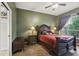 Cozy bedroom with hardwood floors, ceiling fan, and a large window offering natural light at 1641 Bayfield Ct, Trinity, FL 34655