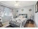 Cozy bedroom with decorative wall art, ceiling fan, and unique curtains at 1641 Bayfield Ct, Trinity, FL 34655