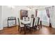 Elegant dining room with modern chandelier, seating for six, and ample natural light at 1641 Bayfield Ct, Trinity, FL 34655