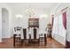 Elegant dining room with modern chandelier, seating for six, and ample natural light at 1641 Bayfield Ct, Trinity, FL 34655