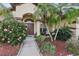 Inviting home with lush landscaping, featuring a welcoming entryway and meticulously maintained garden beds at 1641 Bayfield Ct, Trinity, FL 34655