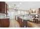 Large kitchen with a center island, stainless steel appliances, and an open layout to the dining and living areas at 1641 Bayfield Ct, Trinity, FL 34655