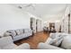 Open-concept living room and dining area with hard wood floors, ample seating and natural light at 1641 Bayfield Ct, Trinity, FL 34655