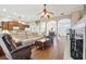 Spacious living area with fireplace, fan, adjacent to a modern kitchen, with abundant light at 1641 Bayfield Ct, Trinity, FL 34655