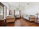 Bright living room featuring hardwood floors, large arched windows, neutral sofas and a ceiling fan at 1641 Bayfield Ct, Trinity, FL 34655
