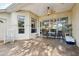 Covered patio with wood tile flooring, ceiling fan, and plenty of room for an outdoor dining set at 1641 Bayfield Ct, Trinity, FL 34655