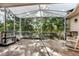 Enclosed lanai with wood tile flooring and screened walls, offering an outdoor living space at 1641 Bayfield Ct, Trinity, FL 34655