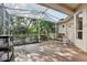 Enclosed lanai with wood tile flooring and screened walls, offering an outdoor living space at 1641 Bayfield Ct, Trinity, FL 34655