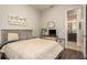 Inviting bedroom with light color palette, wood-look flooring, and ensuite bathroom access at 1771 Whitewillow Dr, Wesley Chapel, FL 33543