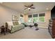 Bonus room with exercise equipment, a ceiling fan, and three bright windows at 1771 Whitewillow Dr, Wesley Chapel, FL 33543