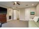 Bonus room with a small couch, TV, and two doors, one leading to the bathroom at 1771 Whitewillow Dr, Wesley Chapel, FL 33543