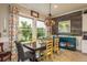 Cozy dining room with wood-look flooring, large windows, and stylish decor at 1771 Whitewillow Dr, Wesley Chapel, FL 33543