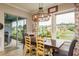 Comfortable dining area with a view of the backyard and adjacent outdoor space at 1771 Whitewillow Dr, Wesley Chapel, FL 33543