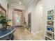 Welcoming entryway with tile flooring, arched doorways, and stylish decor at 1771 Whitewillow Dr, Wesley Chapel, FL 33543