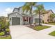 Charming home with a three-car garage, mature landscaping, and symmetrical curb appeal at 1771 Whitewillow Dr, Wesley Chapel, FL 33543