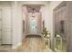 Elegant foyer featuring decorative tile ceiling, wood-look floors, and a stylish front door at 1771 Whitewillow Dr, Wesley Chapel, FL 33543