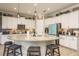 Modern kitchen featuring a large island with granite countertops and white cabinetry at 1771 Whitewillow Dr, Wesley Chapel, FL 33543