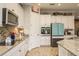 Bright kitchen featuring white cabinetry, stainless steel appliances, and stylish backsplash at 1771 Whitewillow Dr, Wesley Chapel, FL 33543