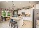 Bright eat-in kitchen featuring a granite island, stainless steel appliances, and brick backsplash at 1771 Whitewillow Dr, Wesley Chapel, FL 33543