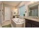 Luxurious main bathroom featuring a soaking tub, separate shower, and dual vanities at 1771 Whitewillow Dr, Wesley Chapel, FL 33543