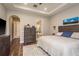 Spacious main bedroom with tray ceiling, hardwood floors, and ensuite bathroom access at 1771 Whitewillow Dr, Wesley Chapel, FL 33543