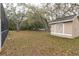 Large backyard featuring a small building and mature trees overlooking the yard at 18328 Treehaven Dr, Hudson, FL 34667