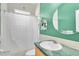 Bathroom featuring a commode, sink with green marble-look countertop, and shower with curtain at 18328 Treehaven Dr, Hudson, FL 34667