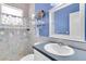 Bathroom featuring seashell-themed shower curtain, small vanity, and mirror at 18328 Treehaven Dr, Hudson, FL 34667