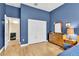 Bedroom with wooden dresser, closet, and light hardwood floors at 18328 Treehaven Dr, Hudson, FL 34667
