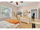 Bedroom with a large window, dresser and vanity combination, and view of the doorway at 18328 Treehaven Dr, Hudson, FL 34667