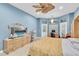 Bedroom with a decorative ceiling fan, light blue walls, and a desk with a view to the pool at 18328 Treehaven Dr, Hudson, FL 34667