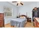 Bedroom featuring wood floors, an area rug, window with blinds and neutral walls at 18328 Treehaven Dr, Hudson, FL 34667