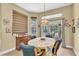 Cozy dining room featuring a decorative light fixture and access to an outdoor patio at 18328 Treehaven Dr, Hudson, FL 34667