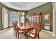 Formal dining room with chandelier, china cabinet and views through the large bay window at 18328 Treehaven Dr, Hudson, FL 34667