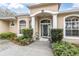 Charming home featuring a covered front entrance with classic columns and lush landscaping at 18328 Treehaven Dr, Hudson, FL 34667
