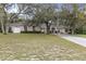 Charming home featuring a well-manicured lawn and a welcoming entrance at 18328 Treehaven Dr, Hudson, FL 34667