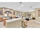 Open-concept kitchen and living area featuring a breakfast bar and neutral decor at 18328 Treehaven Dr, Hudson, FL 34667
