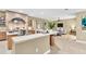 Open-concept kitchen and living area with stylish countertops and stainless steel appliances at 18328 Treehaven Dr, Hudson, FL 34667